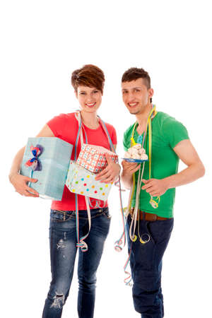 a birthdayboy and a birthdaygirl with a lot of presents an a birthdaycakeの写真素材