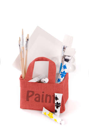 a red bag with drawing and painting equipment on a white backgroundの写真素材