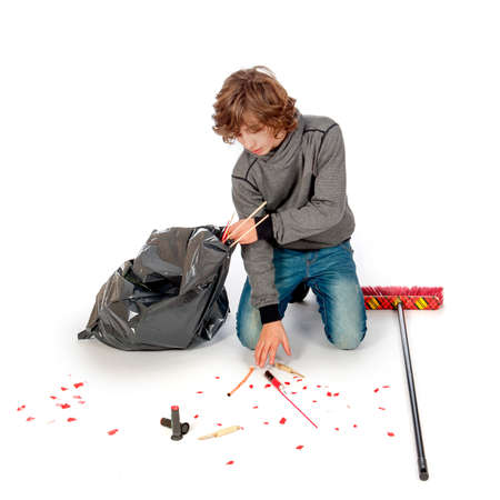 a teenage boy is cleaning up the mess on new years dayの写真素材