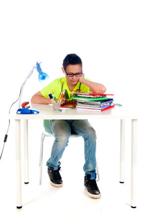 a desk for a teenager to make homework. Desk with books, exercise books, lamp; pen, pencils and a chair.の写真素材