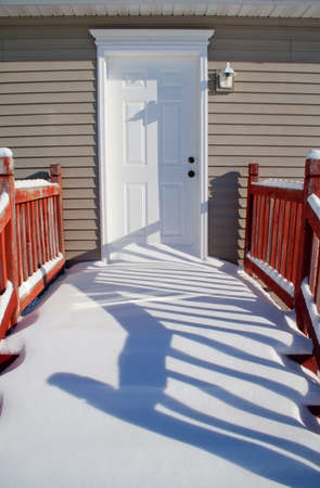 Snow covered porch that needs to be shoveled の写真素材