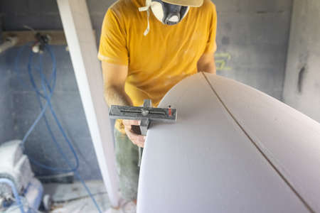 Surfboard Modeling Workshop - Man perfecting the modeling of a surfboard.. Shaper Concept.の写真素材