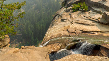 A beautiful view of a waterfall from a cliffの写真素材