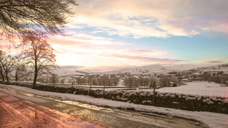 A wet road and a snowy landscape
の写真素材