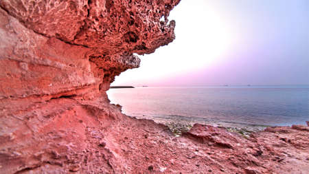 A red rocky cliff shoreの写真素材