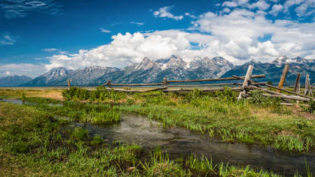 A wooden fence a fresh spring in the mountainsの写真素材