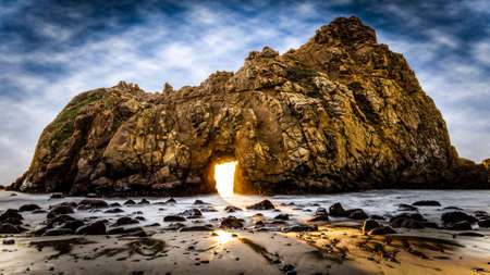 A gate in a shore large rockの写真素材