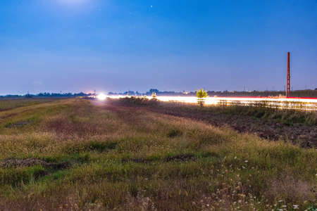 Car light trails and stars sceneの写真素材