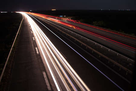 Light trails under the bridge at nightの写真素材