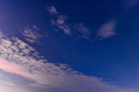 White clouds in the night and stars