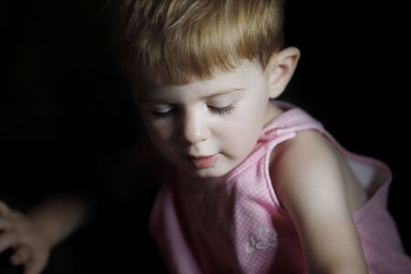  girl with a lighted hece looking down at somethingの写真素材