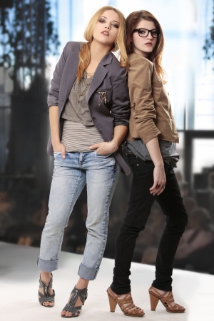 teenage girls at fashion show presenting fancy clothing and cool accessories looking at the camera の写真素材