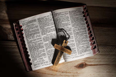 Cross in bible on wooden backgroundの写真素材