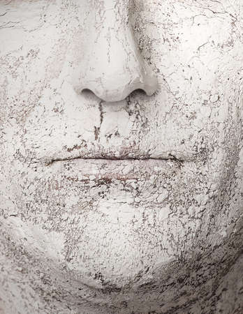 Face with broken clay, dry skinの写真素材