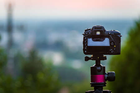 Camera on a tripod watching at a cityの写真素材