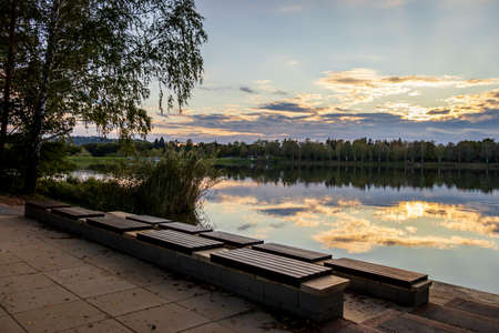 Outdoor benches at Lake Gebart (Gebarti-to) in autumn in Zalaegerszeg, Hungaryの写真素材