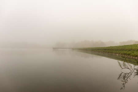 Foggy autumn morning at Lake Gebart in City Zalaegerszeg, Hungaryの写真素材