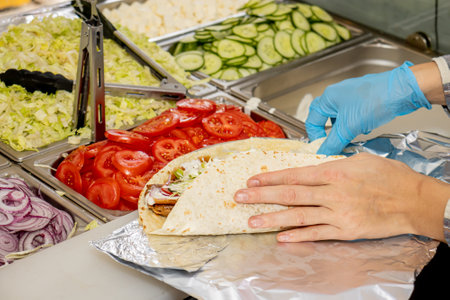 Durum Kebab is being prepared in a local pizza and gyros restaurantの写真素材