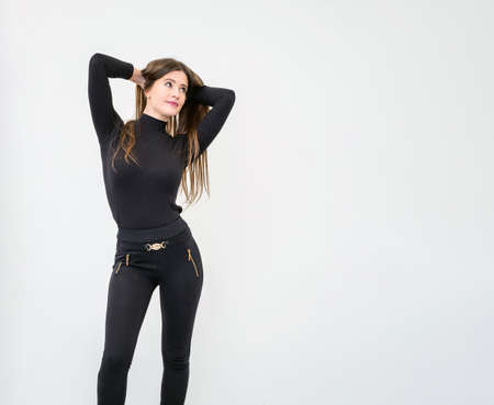 Beautiful young woman standing over white wallの写真素材