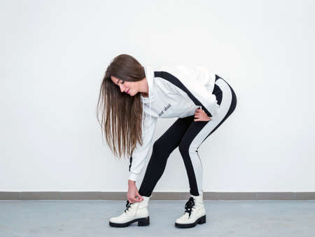 Beautiful young woman over white wallの写真素材