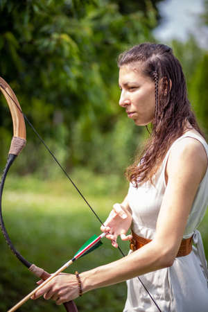 A Hungarian woman in a linen dress standing with a bowの写真素材