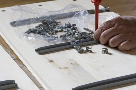 assembling furniture at home, hand with screwdriverの写真素材