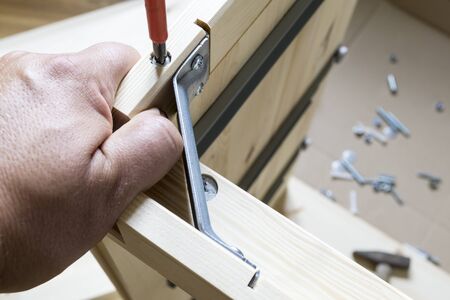 assembling furniture at home, hand with screwdriverの写真素材