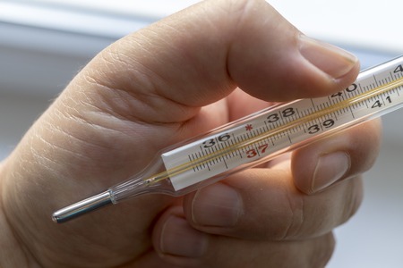 Close Up Image Of Thermometer Showing High Temperature
Human hand holding medicine healthcare thermometerの写真素材