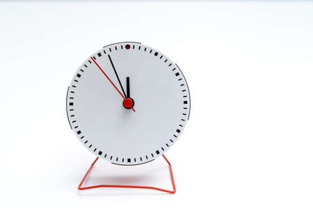 white simple clock, 5 minutes to 12