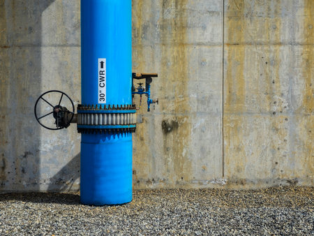 Cooling water pipe on the concrete wall of a building with copy spaceの写真素材