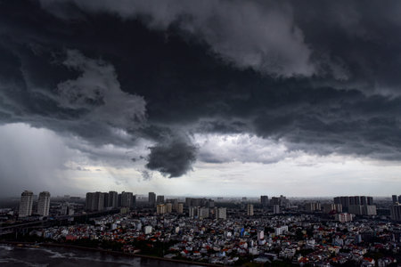 A city with a large cloud in the sky. The cloud is dark and stormy. The city is full of tall...