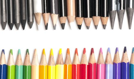 Collection of very brightly colored pencils opposing black and white pencilsの写真素材