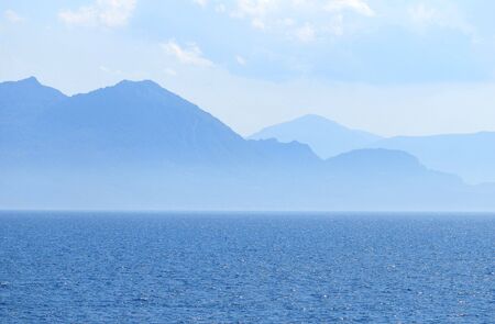 Contour of mountains in the background of a sea scape の写真素材