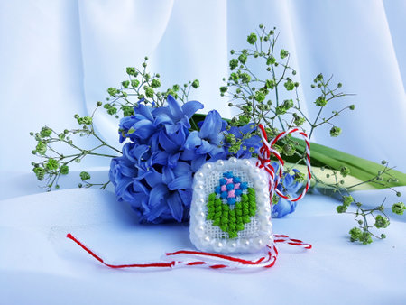 Traditional sewing pattern with red and white string, known as Martisor. It is a Romanian traditional symbol of the beginning of spring. Isolated on white background.の写真素材