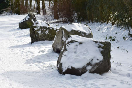 Decorative stones covered with snow in the park.の写真素材
