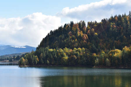 View of Colibita lake in Carpathian mountains in Romania,Transylvania, Bistrita Nasaud county. Autumn forest.の写真素材
