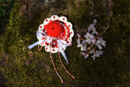 Handmade crocheted Martisor, with red and white string. It is a Romanian traditional symbol of the beginning of spring.の写真素材