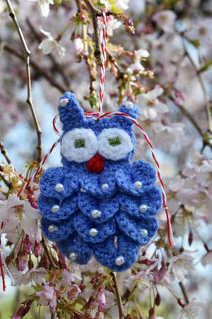 Handmade crocheted Martisor, with red and white string. It is a Romanian traditional symbol of the beginning of spring.の写真素材