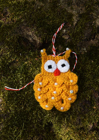 Handmade crocheted Martisor, with red and white string. It is a Romanian traditional symbol of the beginning of spring.の写真素材