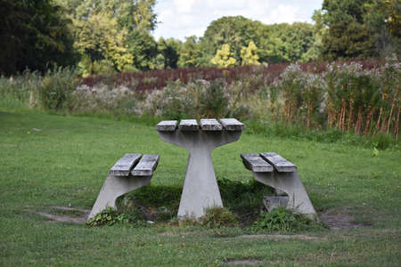 Wooden table with benches in the city park.