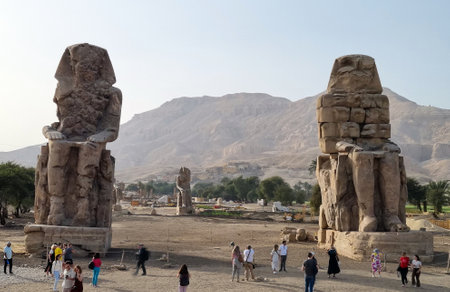 22- March- 2022. Colossi of Memnon, are two massive monumental stone statues, of Pharaoh Amenhotep III (1386-1353 BCE) from the 18th Dynasty of ancient Egypt. Tourists visiting Colossi of Memnon.のeditorial素材