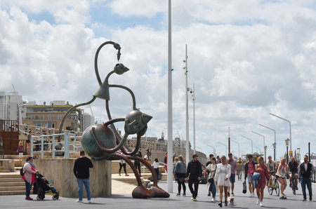 July- 29- 2020. View of the Boulevard of Scheveningen Beach in Netherlands, with cafes, restaurants and walking tourists, on a beautiful sunny day.のeditorial素材