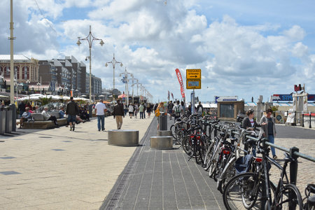 July- 29- 2020. View of the Boulevard of Scheveningen Beach in Netherlands, with cafes, restaurants and walking tourists, on a beautiful sunny day.のeditorial素材