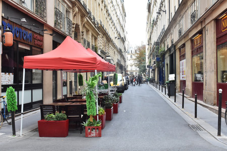 01-September 2020. Street view with beautiful buildings and cafe terrace in Paris, France.
