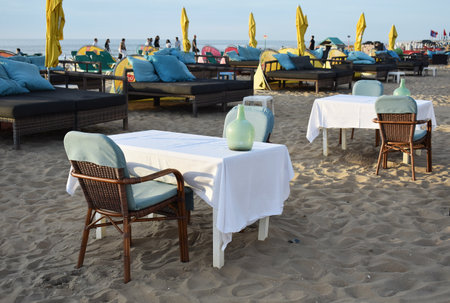 July- 18- 2020. Empty sun loungers, tables and chairs, on Scheveningen beach at North Sea, Netherlands.のeditorial素材