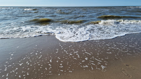 North Sea, Kijkduin, Netherlands. Waves breaking on the sandy shore of the North Sea, in spring.の写真素材