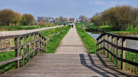 Old wooden bridge over a small canal in Amstelveen, Netherlands. Springlandscape.の写真素材