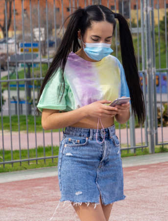 small hands with surgical mask on basketball court in summerの写真素材