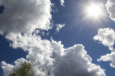 heavenly sky between the white clouds and the radiant sunの写真素材