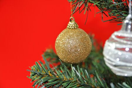 christmas balls on white golden tree with red backgrounds whiteの写真素材
